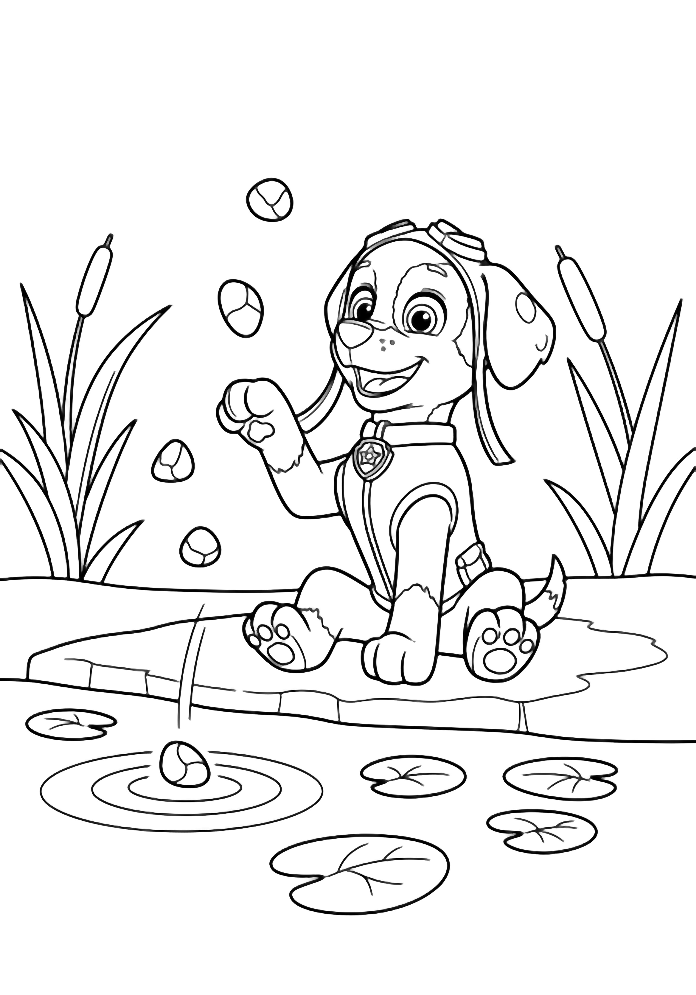 Zuma the pup sits cross-legged on a riverbank, one paw raised mid-toss, pebbles arcing above gentle ripples, reeds framing him and drifting leaves nearby. kleurplaat